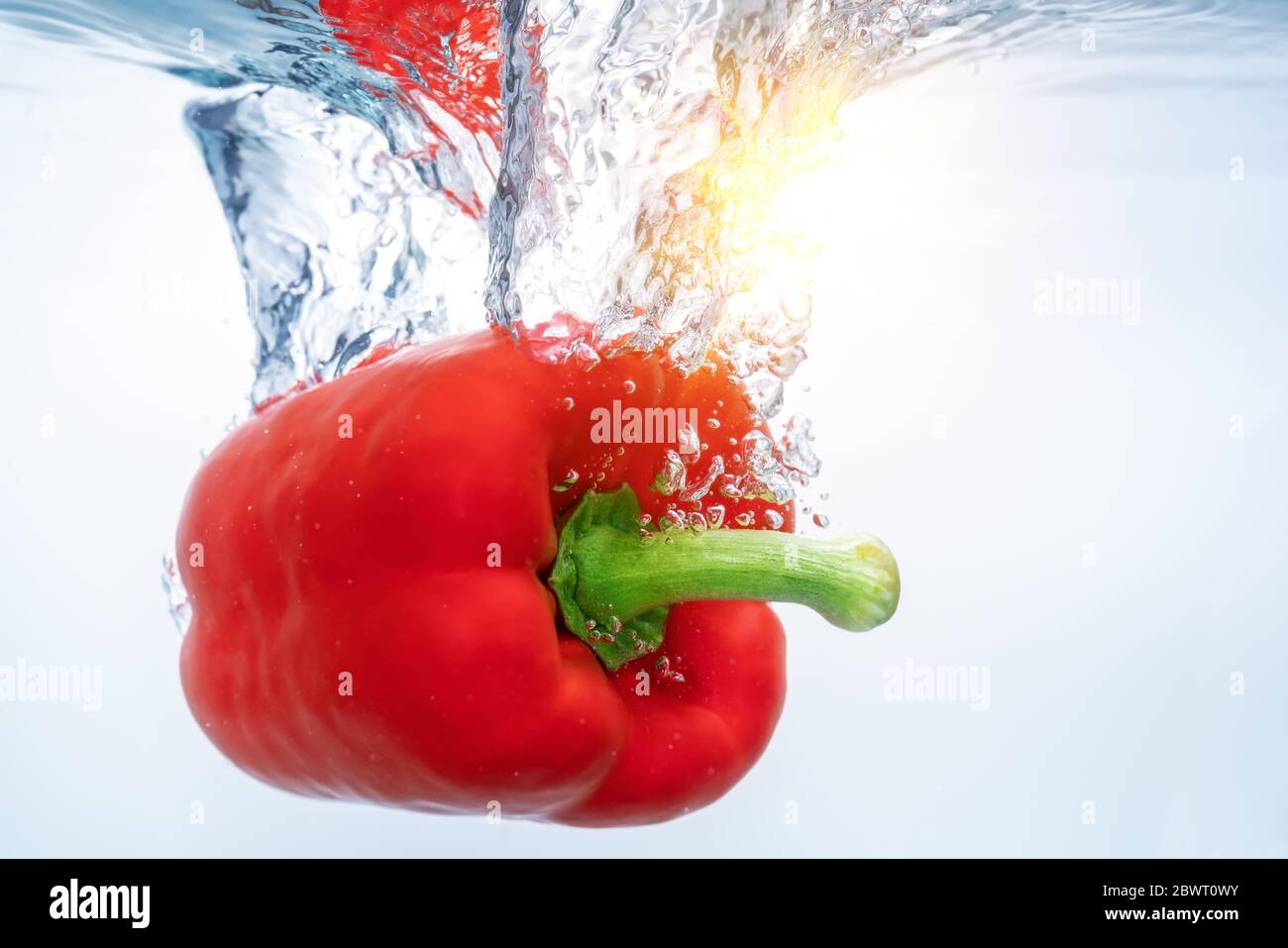 Red bell peppers in ecological clear water, reflected by a solar reflex