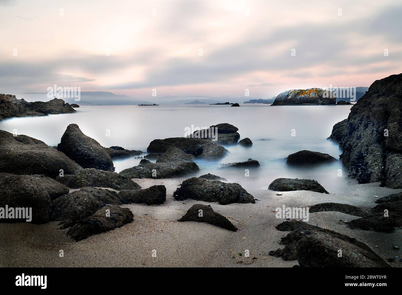 Photograph of long exposure at sunset on unspoilt beach of the coast of vigo in Galicia Stock Photo