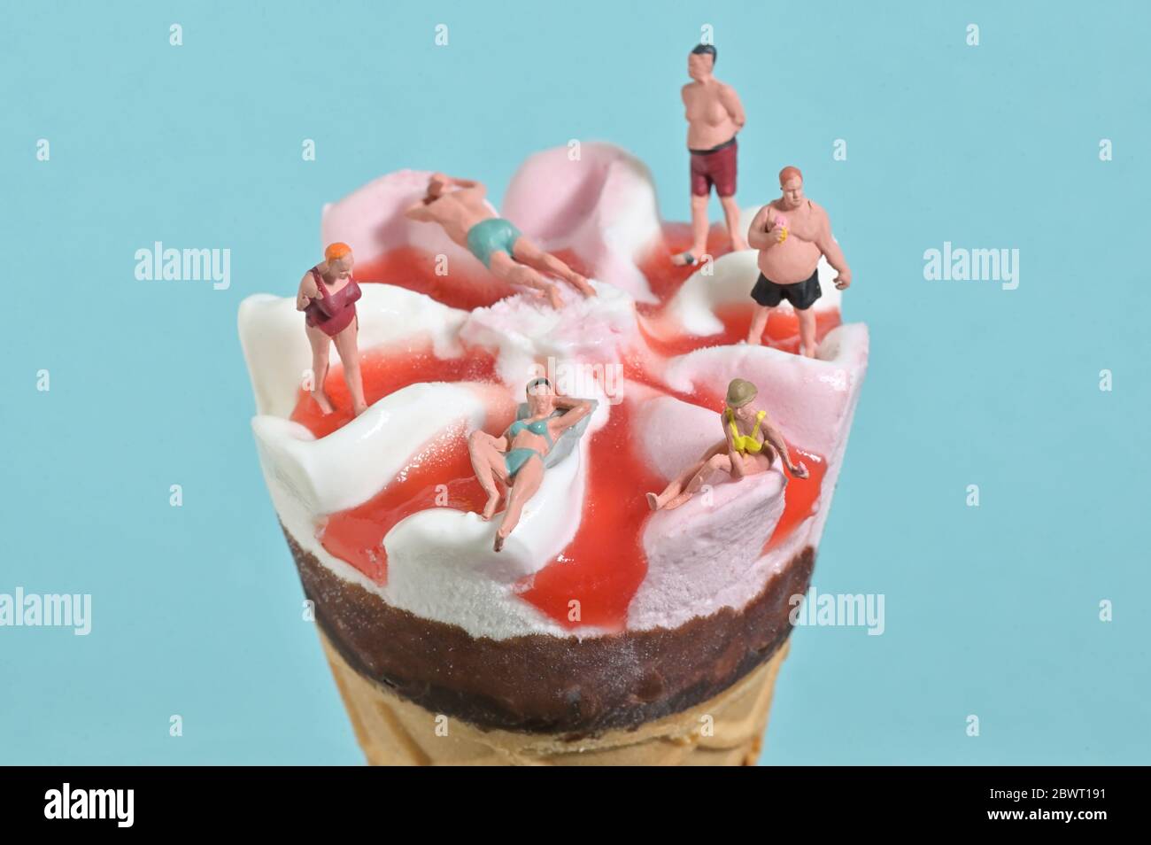 Ice Cream In Waffle Cone and Miniature People on Beach Stock Photo