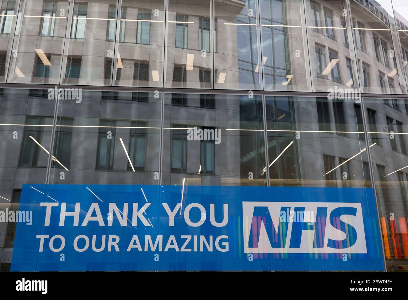 Ten weeks after the UK went into Coronavirus pandemic lockdown, the Office for National Statistics reveal that the total death toll has passed 50,000 covid-19 victims, a large banner thanking and supporting NHS (National Health Service) key workers, is outside newly-completed offices in the City of London, the capital's financial district, on 2nd June 2020, in London, England. Stock Photo