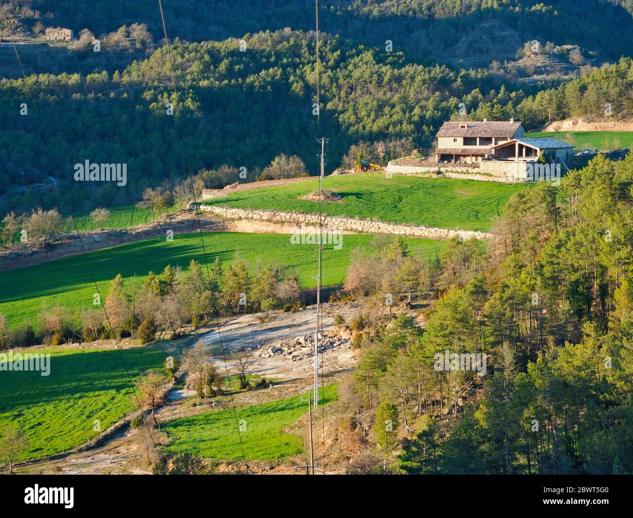 Pasture land, forests and typical catalan farmhouse or ''Masia''. LluçÃ  village countryside. Lluçanès region, Barcelona province, Catalonia, Spain. Stock Photo