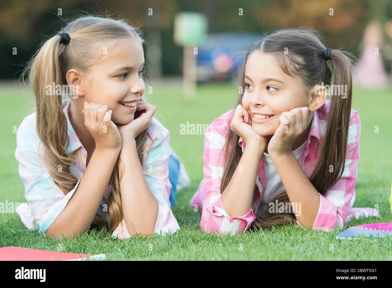 Youre awesome just like me. Happy children relax on green grass. Beauty look of small children. Little children enjoy happy childhood. International childrens day. Having friends is good for children. Stock Photo