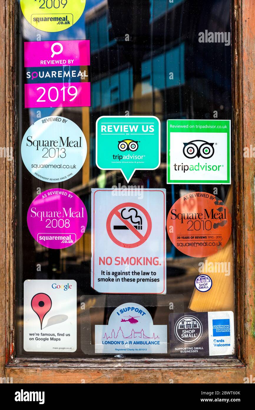 Various food recommendation stickers on a restaurant door, Trip Advisor, SquareMeal, London, UK Stock Photo