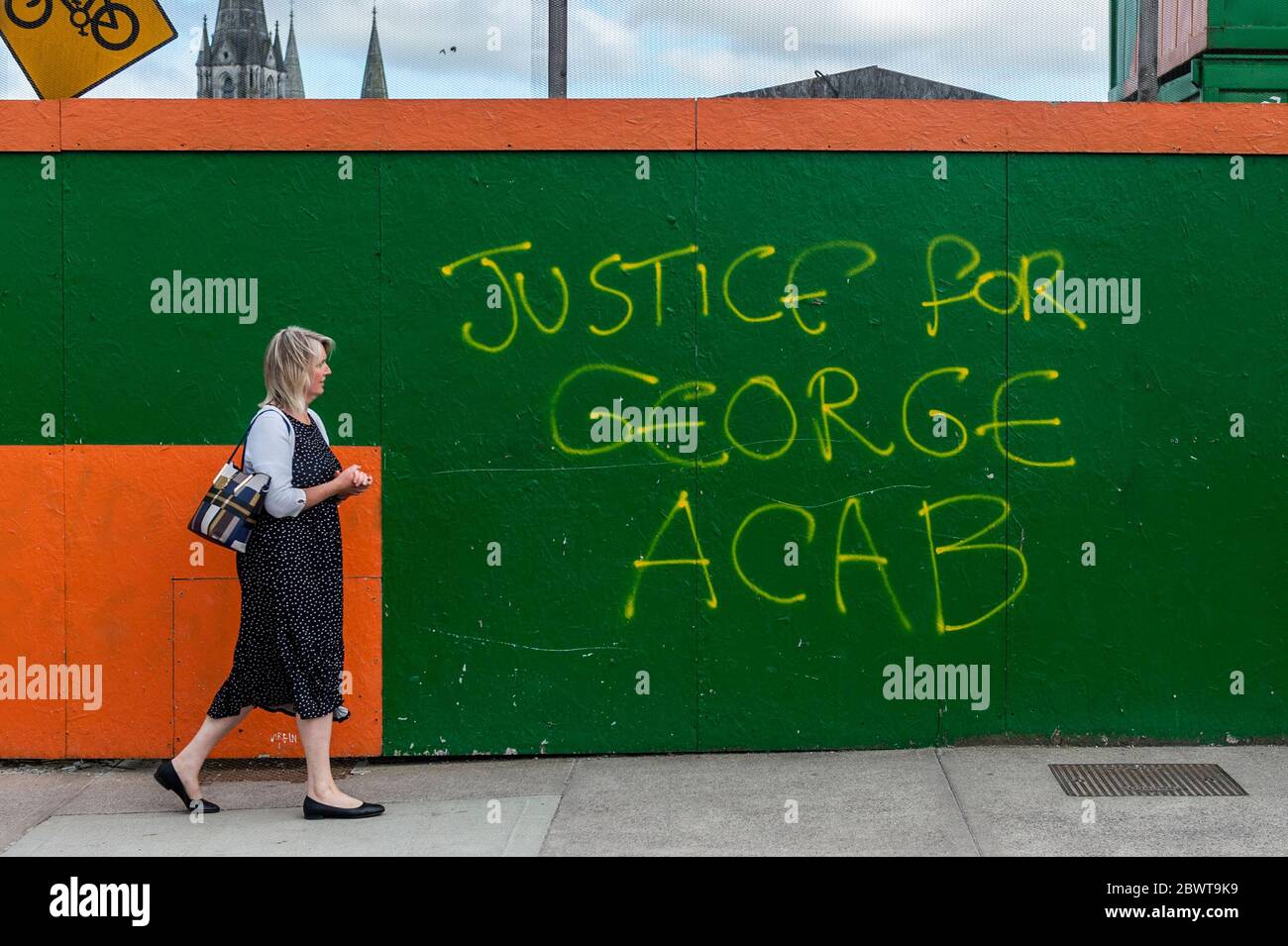 Cork, Ireland. 3rd June, 2020. A woman walks past George Floyd ACAB graffiti in Cork City. The ACAB graffiti is in protest at the killing of George Floyd, an unarmed black man who was murdered by police in Minnesota last week. ACAB has been adopted by protesters and means All Cops Are Bastards. Credit: AG News/Alamy Live News Stock Photo