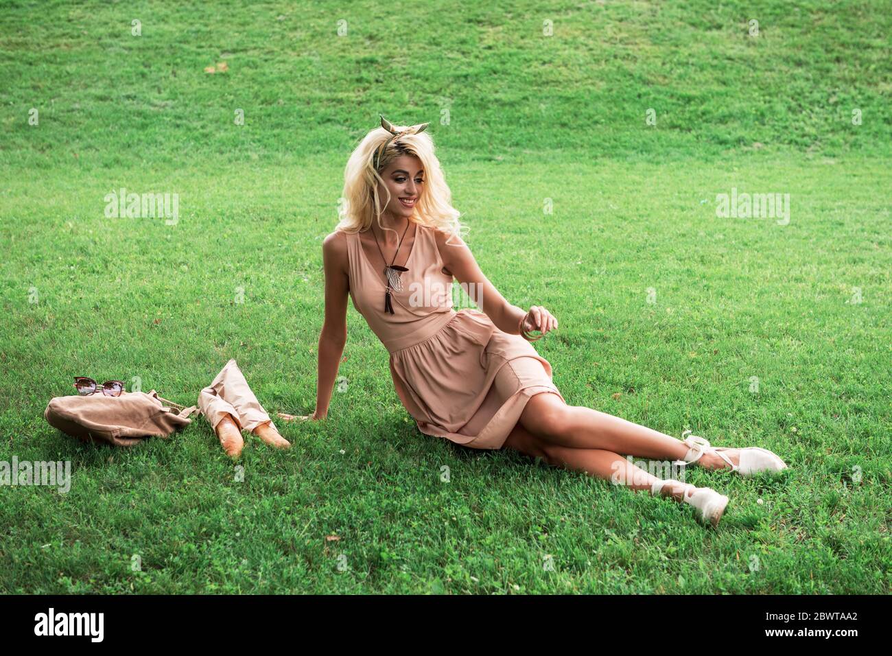 Beauty blonde young woman resting in the park Stock Photo - Alamy