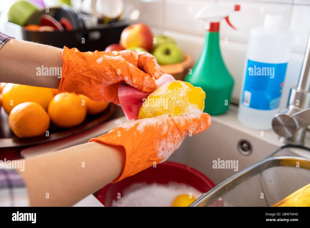 Washing fruits in the kitchen with water and soap Stock Photo Alamy