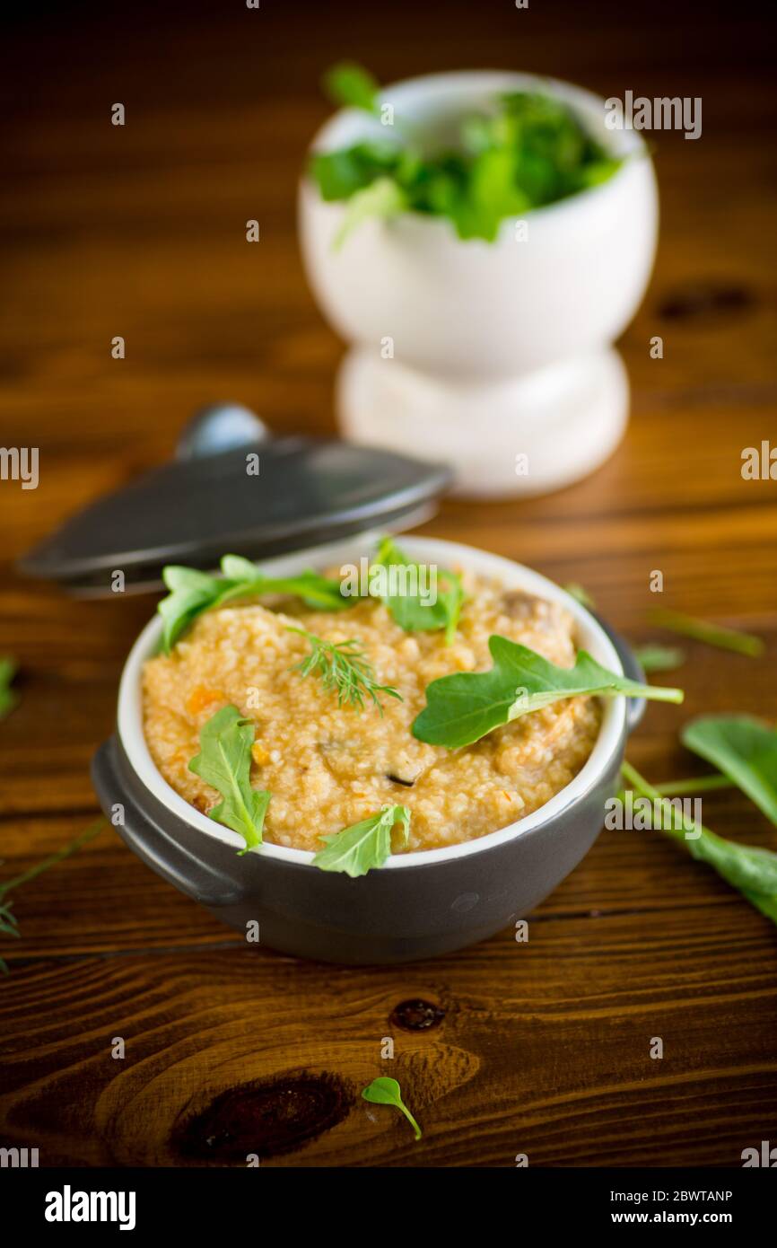 boiled bulgur groats with vegetables and herbs Stock Photo