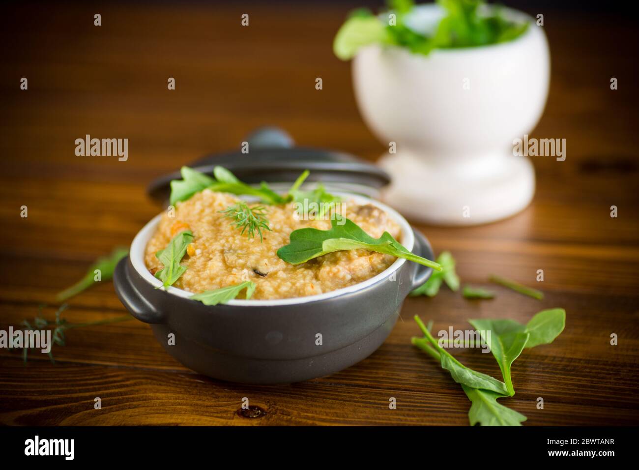 boiled bulgur groats with vegetables and herbs Stock Photo