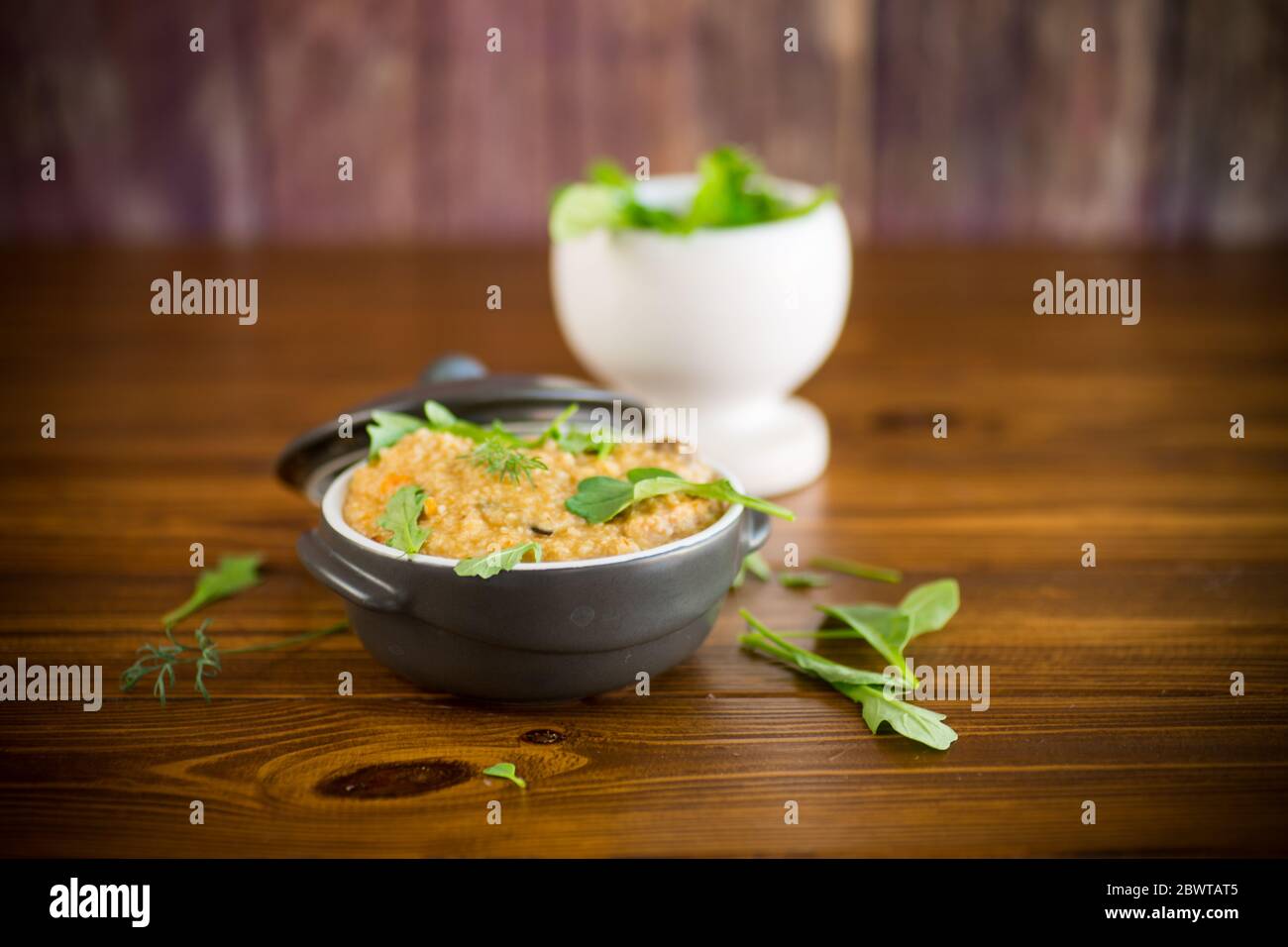 boiled bulgur groats with vegetables and herbs Stock Photo