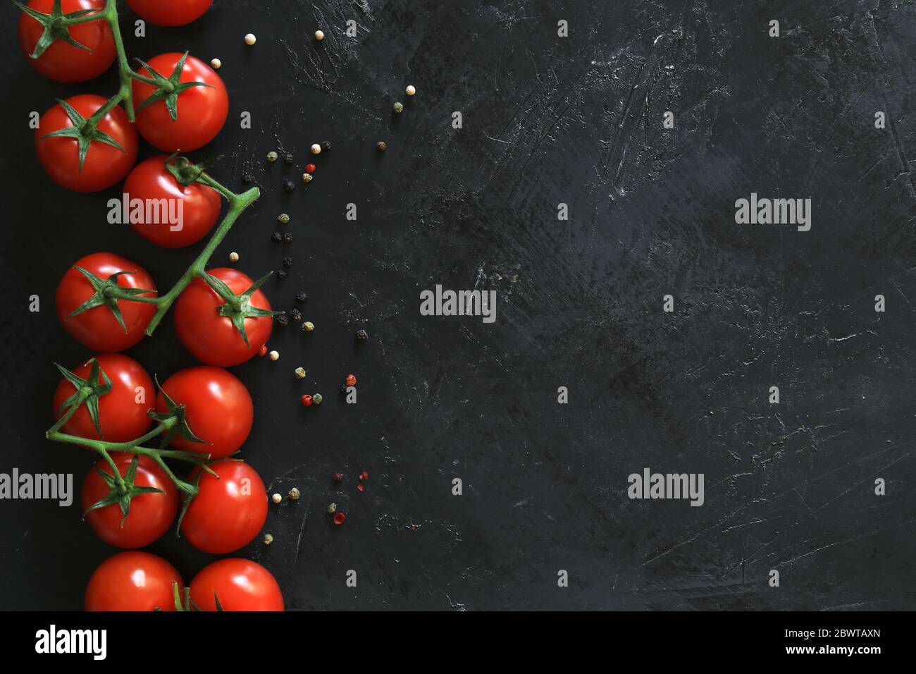 Fresh tomatoes on a black background with spices. Top view Stock Photo ...