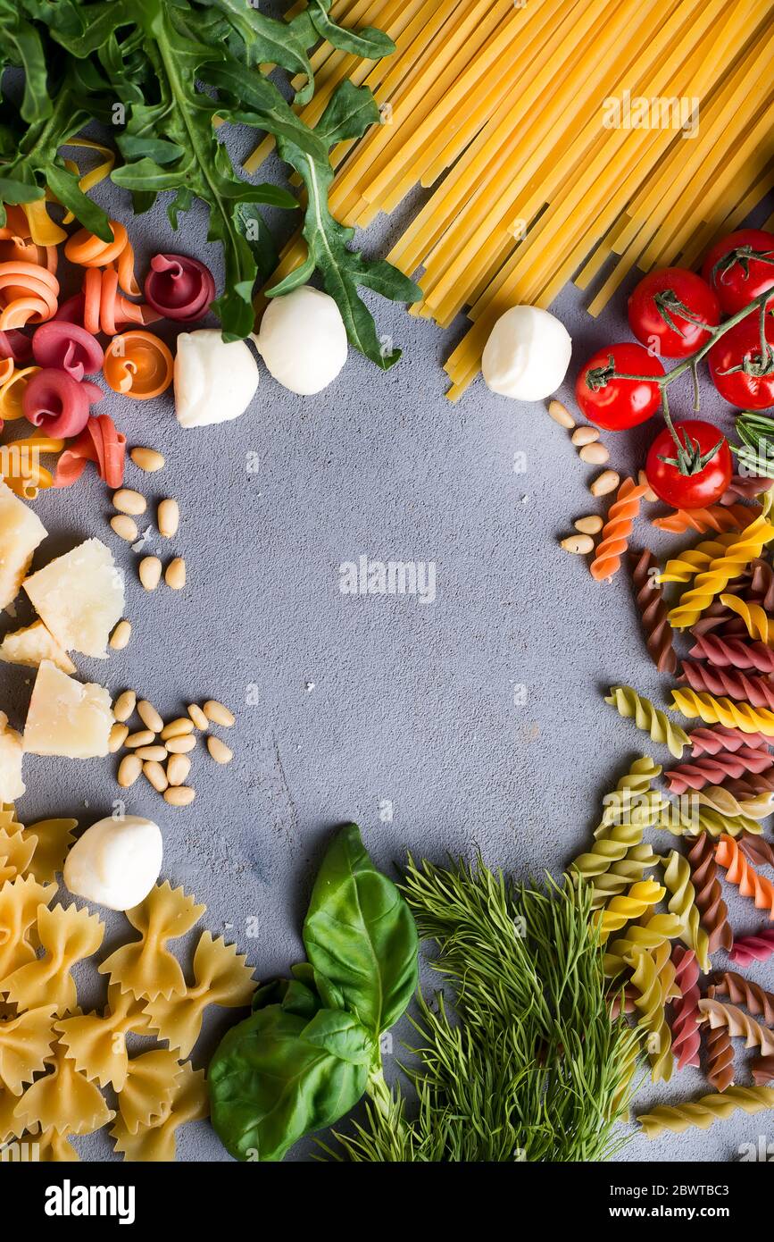 Frame made of vegetables, tomato, pasta, vegetables, cheesse on a stone ...