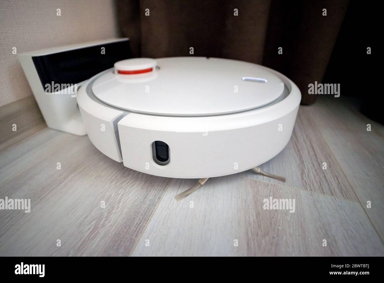 Vacuum cleaner robot on charging dock station Stock Photo Alamy