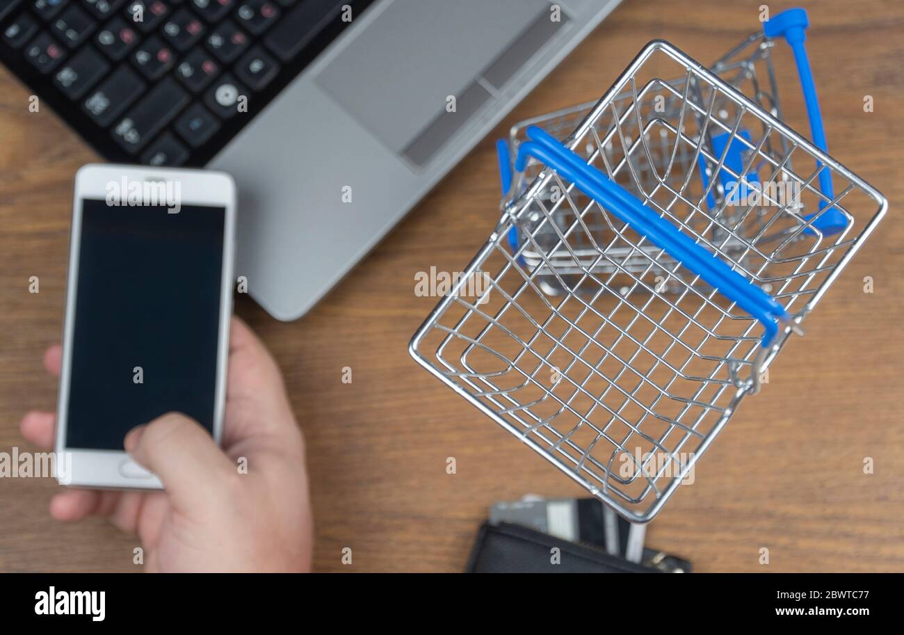 man orders a product on a cell phone. shopping cart. selective focus. online shopping Stock Photo