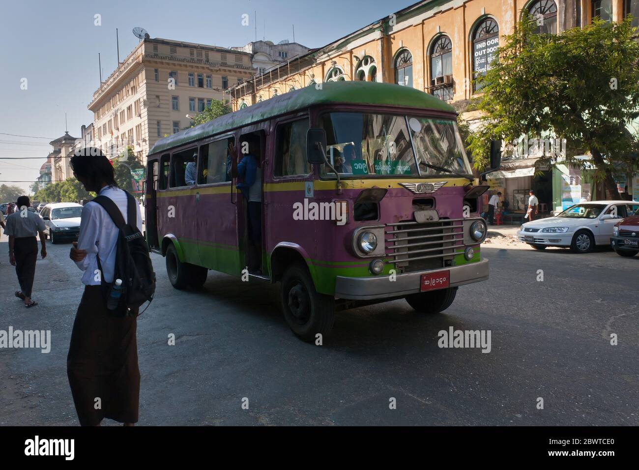 A vintage public bus running on the street of Yangon, Myanmar Stock Photo