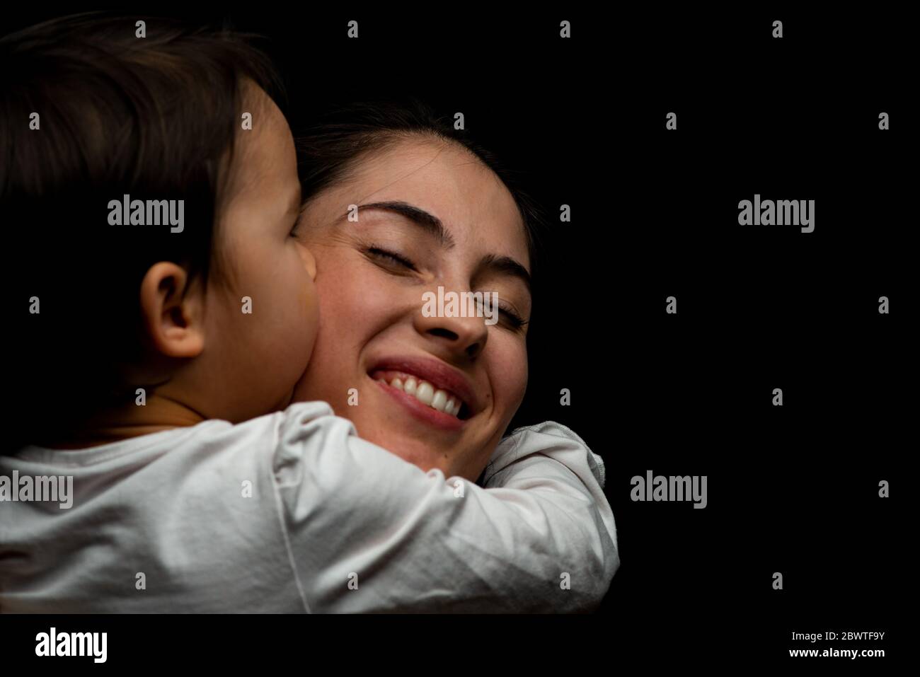 little girl kissing her mother Stock Photo