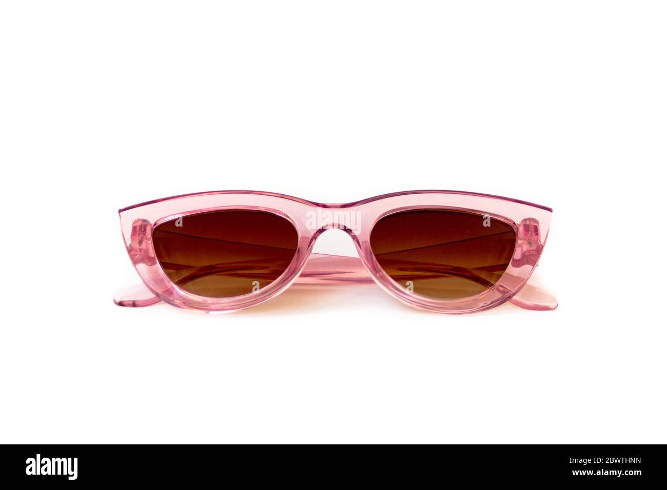 Pink cat eye sunglasses with thick frame at isolated white background, folded front view Stock