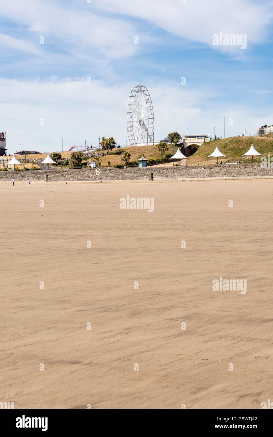 The sandy beach at Barry Island is very quiet on a sunny Spring bank holiday afternoon during the 2020 coronavirus crises. Stock Photo