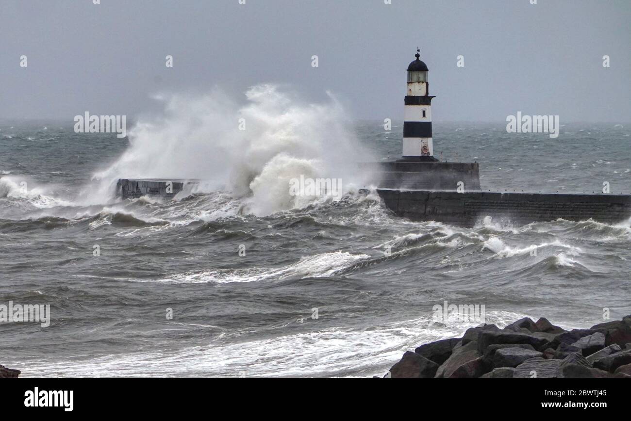 A change in the weather as the mini heatwave comes to an end with rough seas off the north east coast at Seaham in County Durham. Stock Photo
