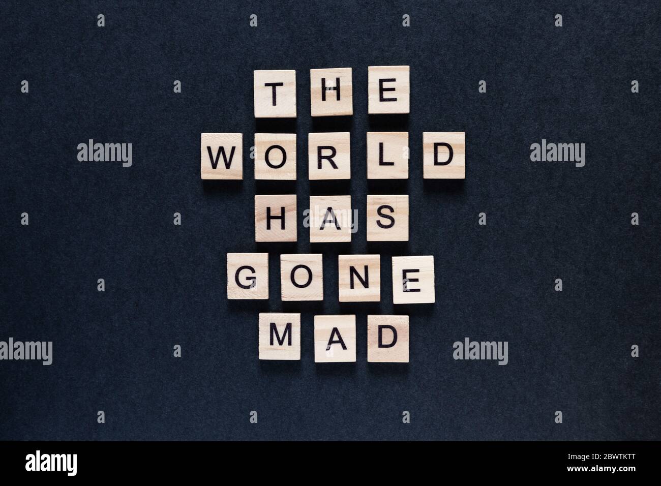 the world has gone mad an inscription on a black background Stock Photo