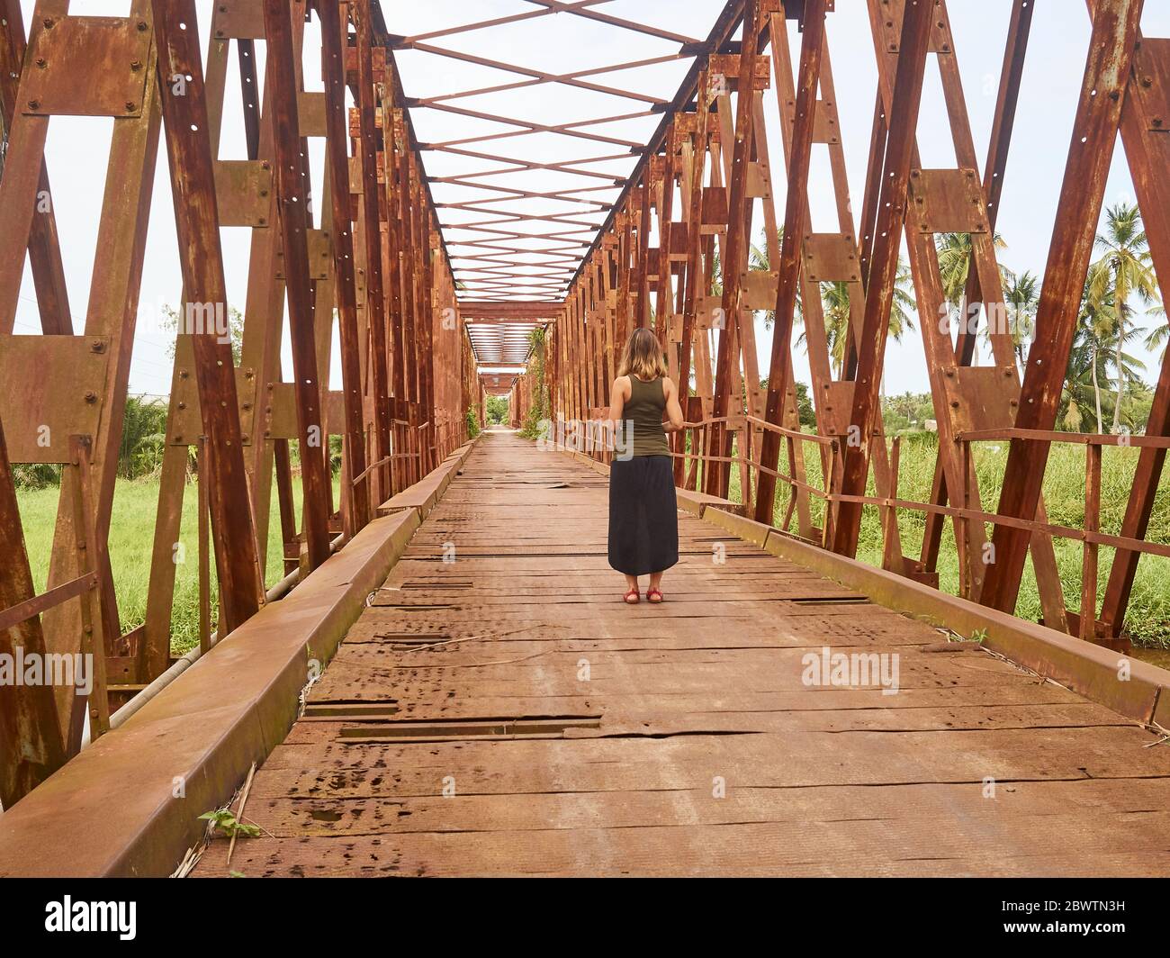 Benin, Mono Department, Grand-Popo, Woman standing in middle of old iron bridge Stock Photo