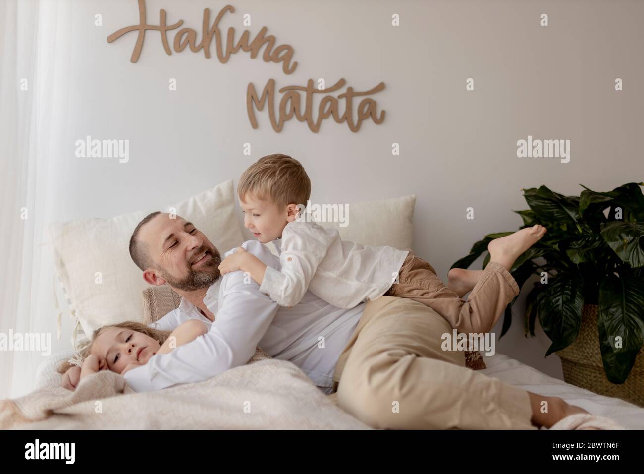 Father spending time with his two children at home Stock Photo