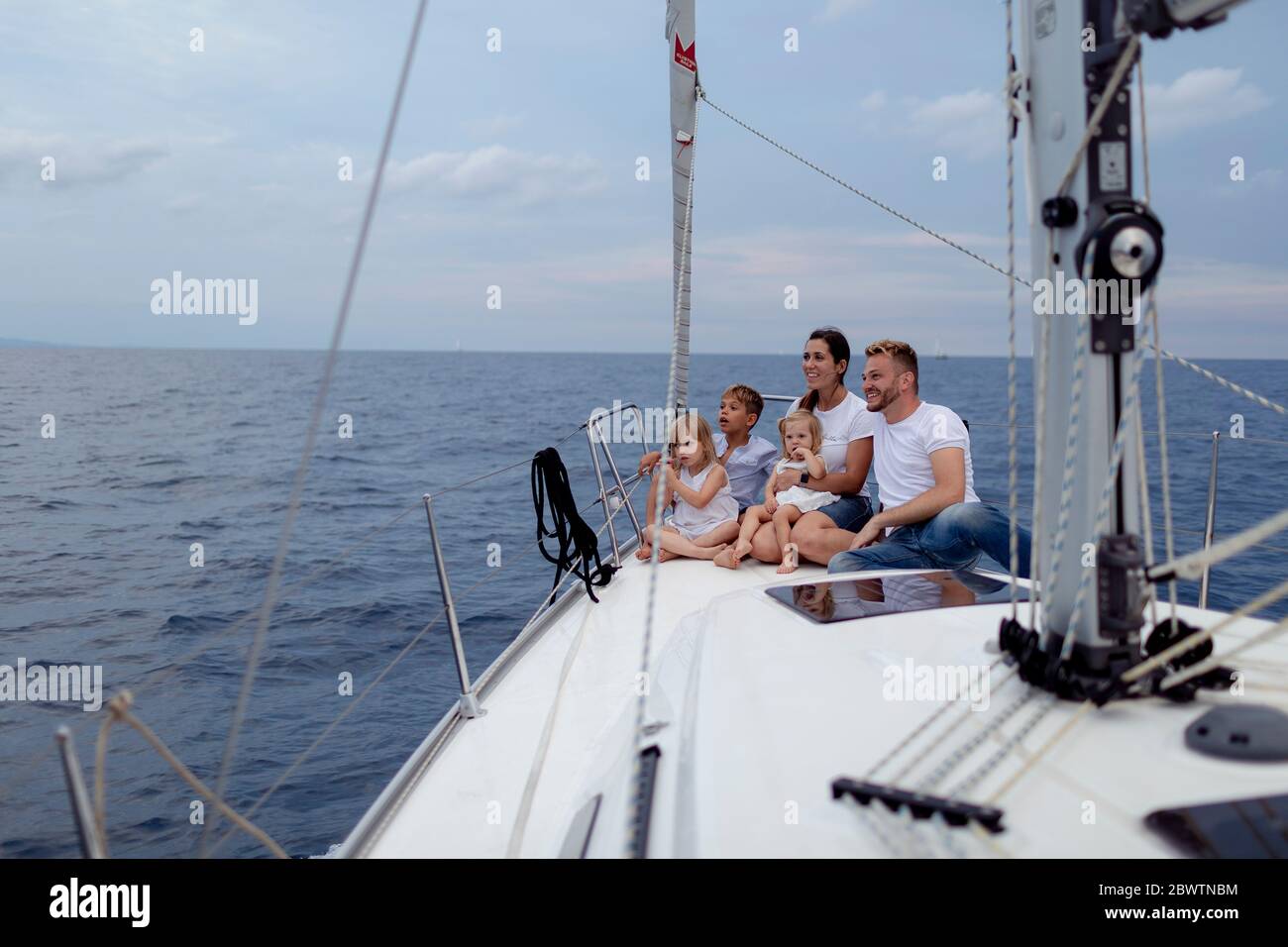 Family sitting on deck during sailing trip Stock Photo Alamy