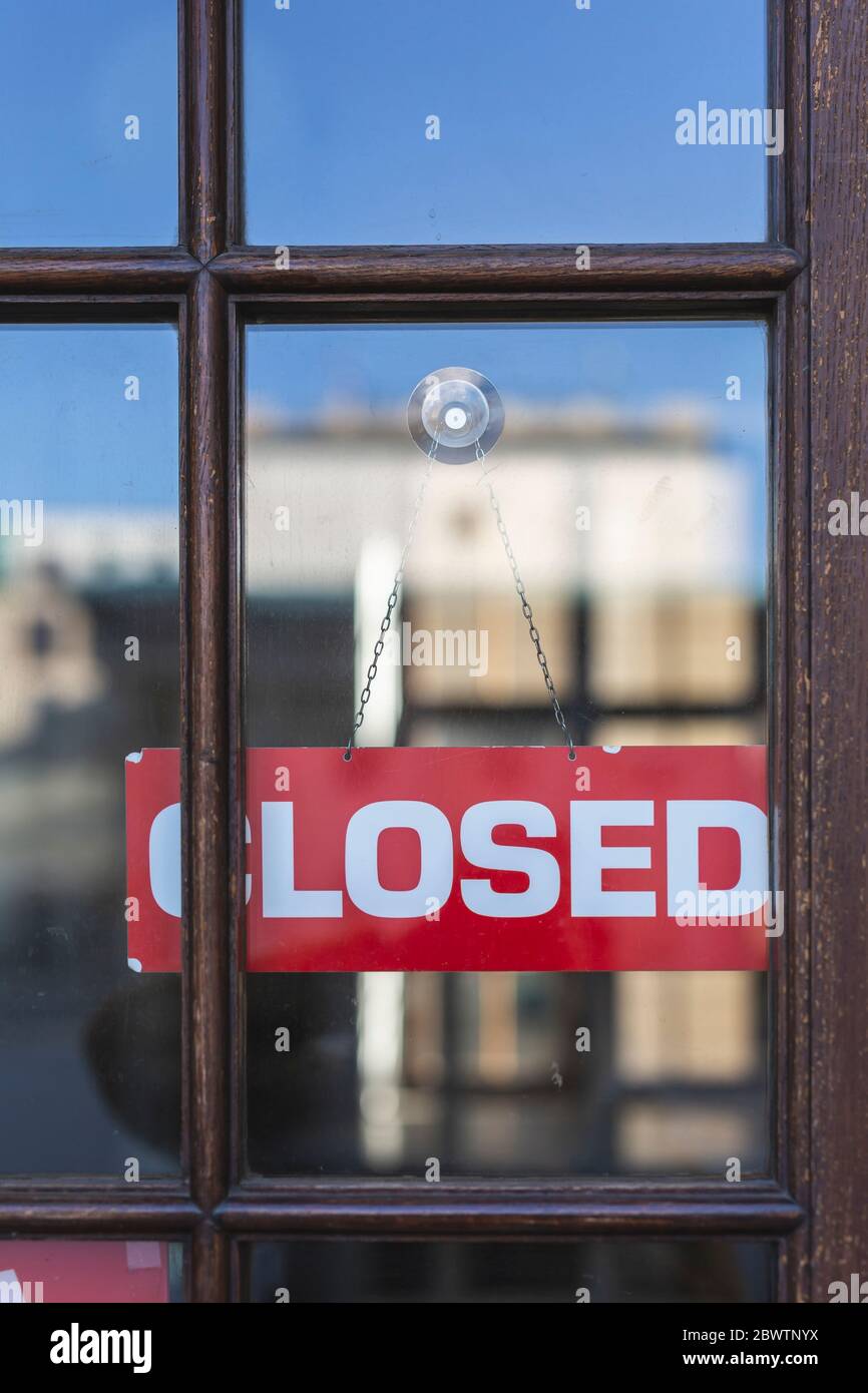 Germany, Closed sign hanging behind store window Stock Photo