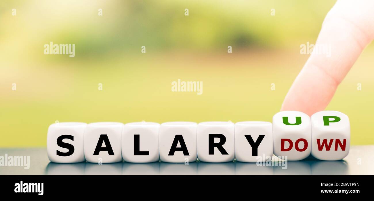 Hand turns dice and changes the expression "salary down" to "salary up