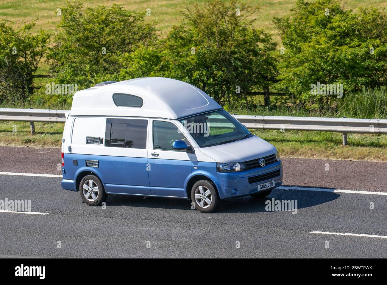 2015 white blue VW Volkswagen Transporter T28 Startline; Vehicular traffic moving vehicles, cars driving vehicle on UK roads, motors, motorhomes, motoring on the M6 motorway highway Stock Photo