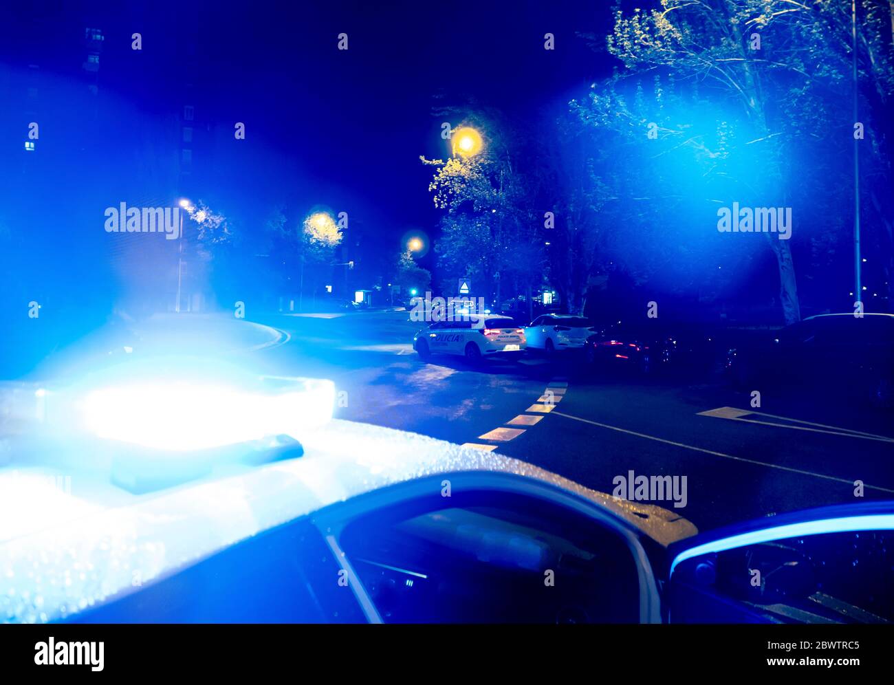 Spain, Madrid, Close-up of police emergency lights glowing during night intervention Stock Photo