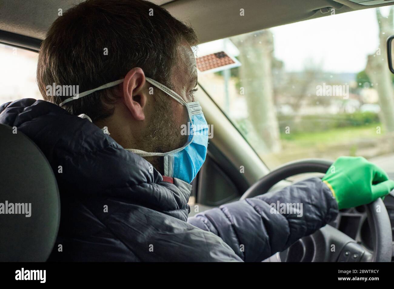 Man wearing mask and gloves driving car in city Stock Photo Alamy