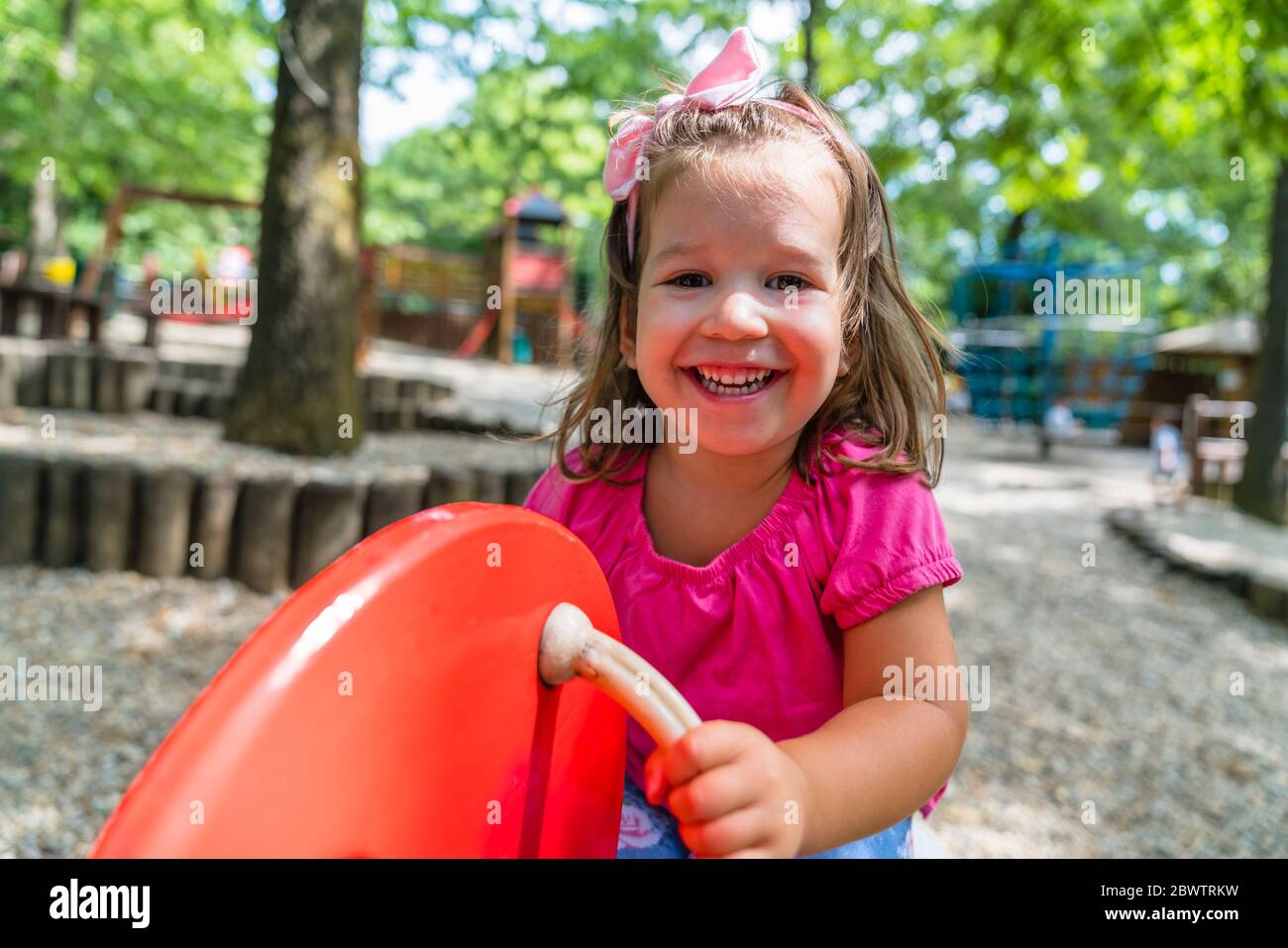 Portrait of happy little girl having fun on playground Stock Photo - Alamy