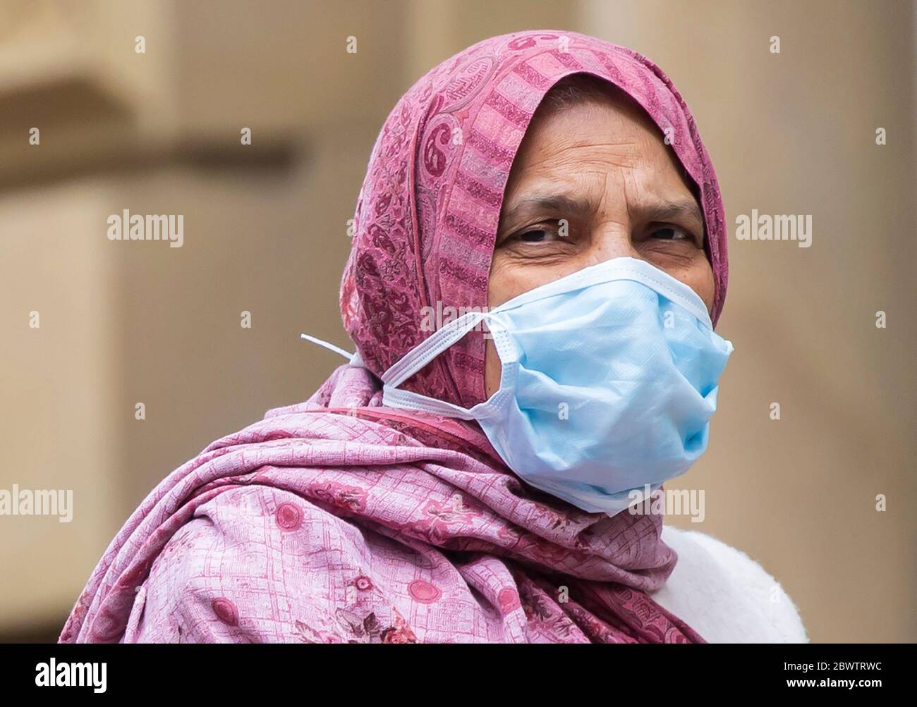 A member of the public wears a face mask in, Bradford in Yorkshire, after Health Secretary Matt Hancock published a new review which found black, Asian and minority ethnic (BAME) people are at significantly higher risk of dying from Covid-19. Stock Photo