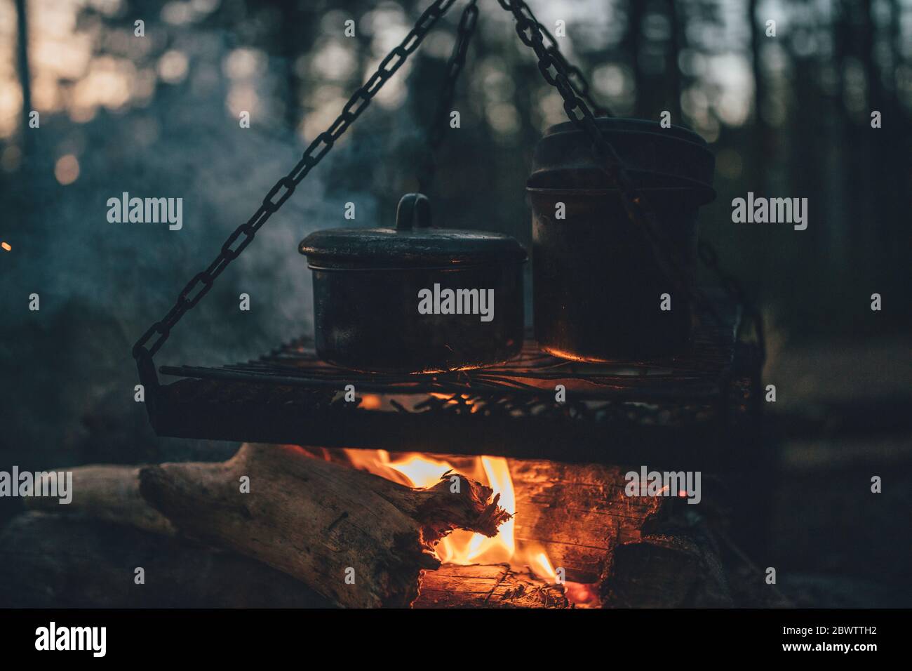 Pots cooking over campfire Stock Photo - Alamy