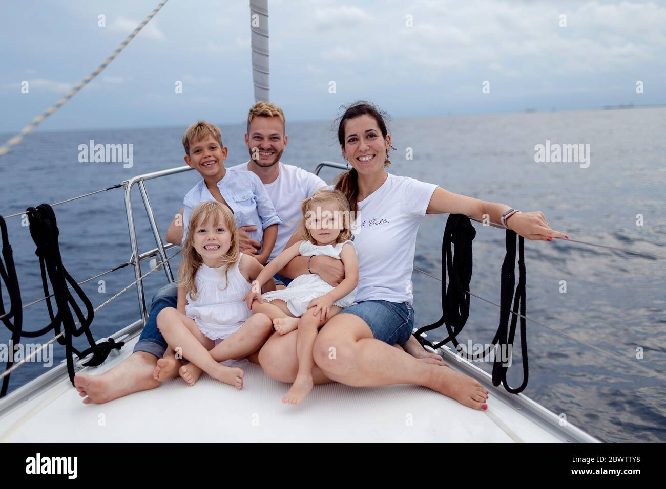 Family sitting on deck during sailing trip Stock Photo Alamy