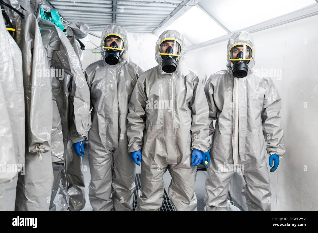 Portrait of sanitation workers standing in protective coverall suits during pandemic Stock Photo
