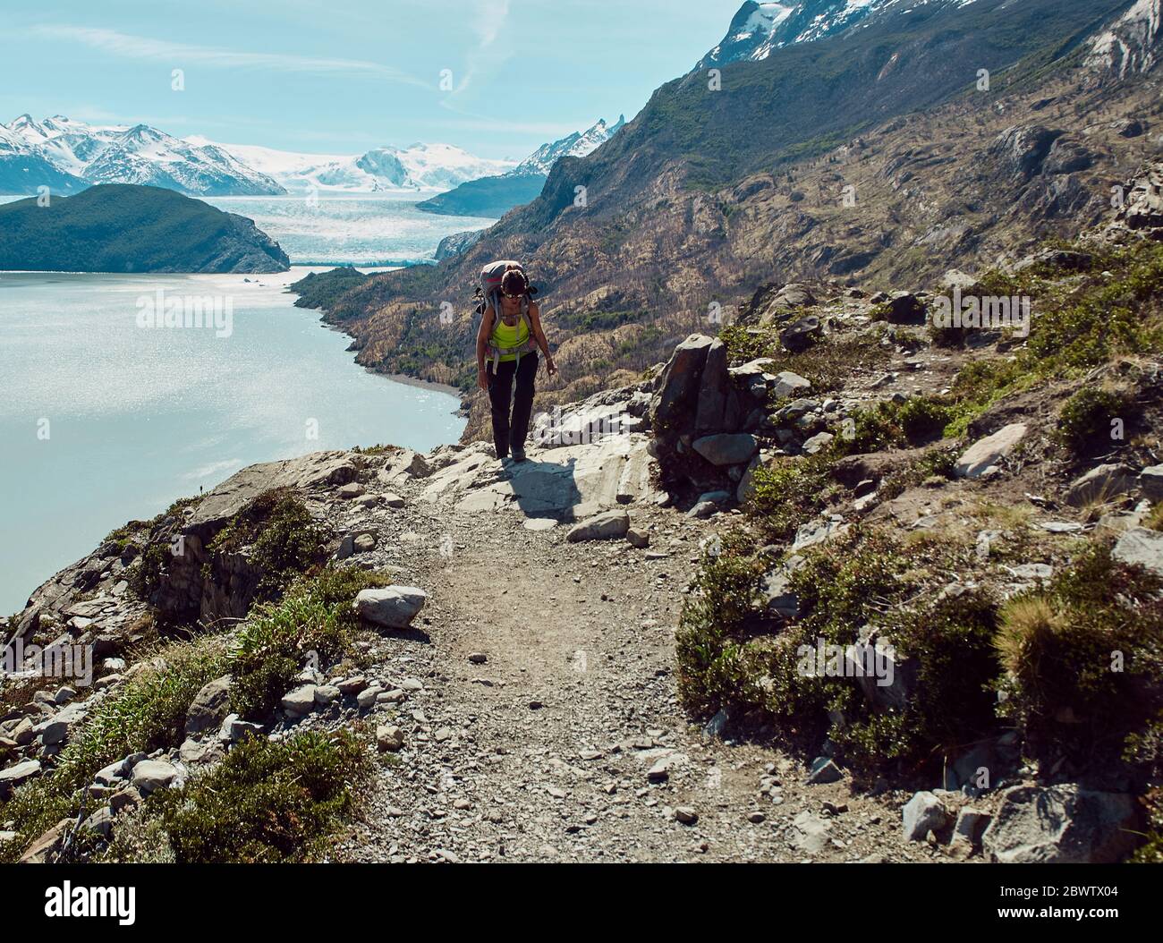 Woman with her backpack doing a mountain trekking, Parque Nacional Torres del Paine, Chile Stock Photo