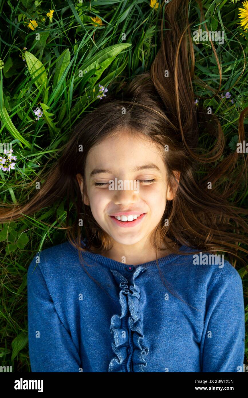 Portrait of girl with eyes closed relaxing on a meadow in spring Stock ...