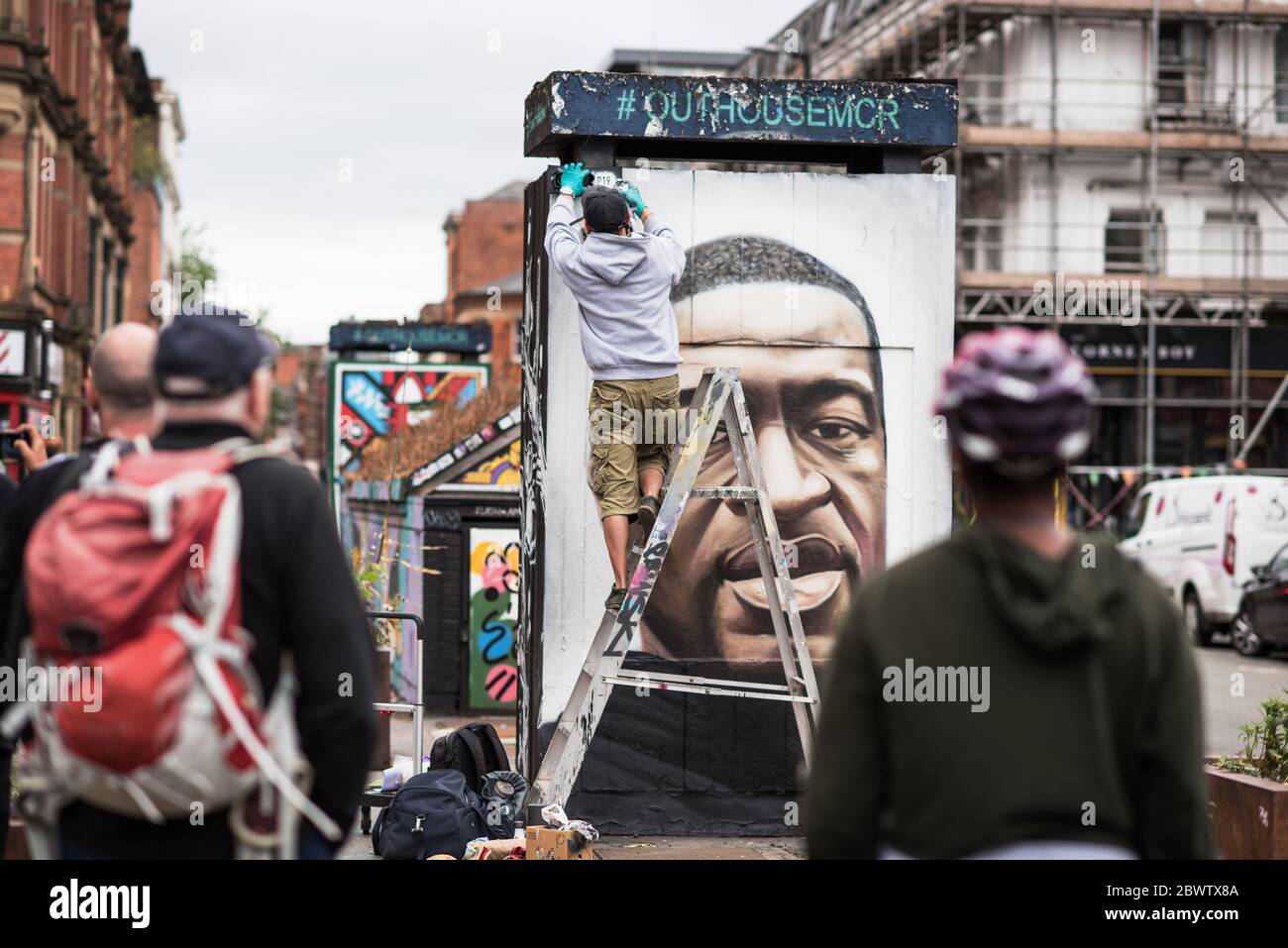 3rd June 2020. Manchester, United Kingdm. Crowds gather in Stevenson Square as French street artist AKSE p19 completes a mural of George Floyd. The mural marks the death of Floyd, a black man, after he was pinned under the knee of a white police officer in Minneapolis for almost nine minutes. Credit: Howard Harrison/Alamy Live News Stock Photo