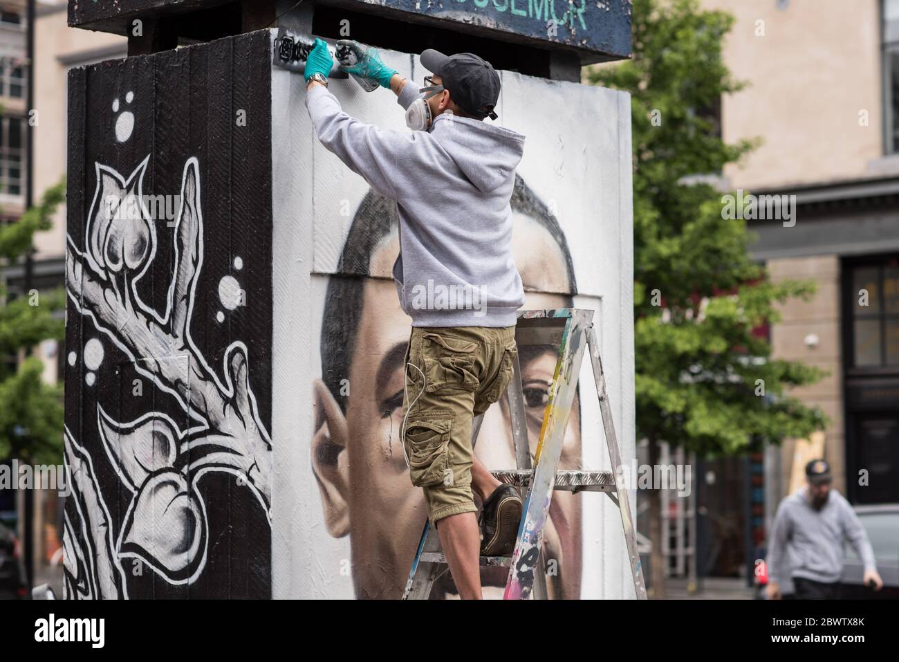 3rd June 2020. Manchester, United Kingdm. Crowds gather in Stevenson Square as French street artist AKSE p19 completes a mural of George Floyd. The mural marks the death of Floyd, a black man, after he was pinned under the knee of a white police officer in Minneapolis for almost nine minutes. Credit: Howard Harrison/Alamy Live News Stock Photo