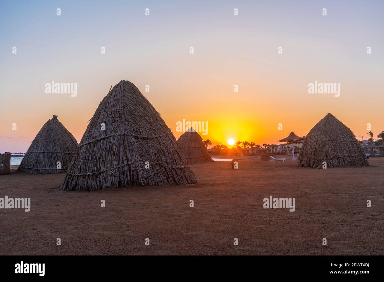 Egypt, Hurghada, Straw huts on sandy beach of Sahl Hasheesh bay at sunrise Stock Photo