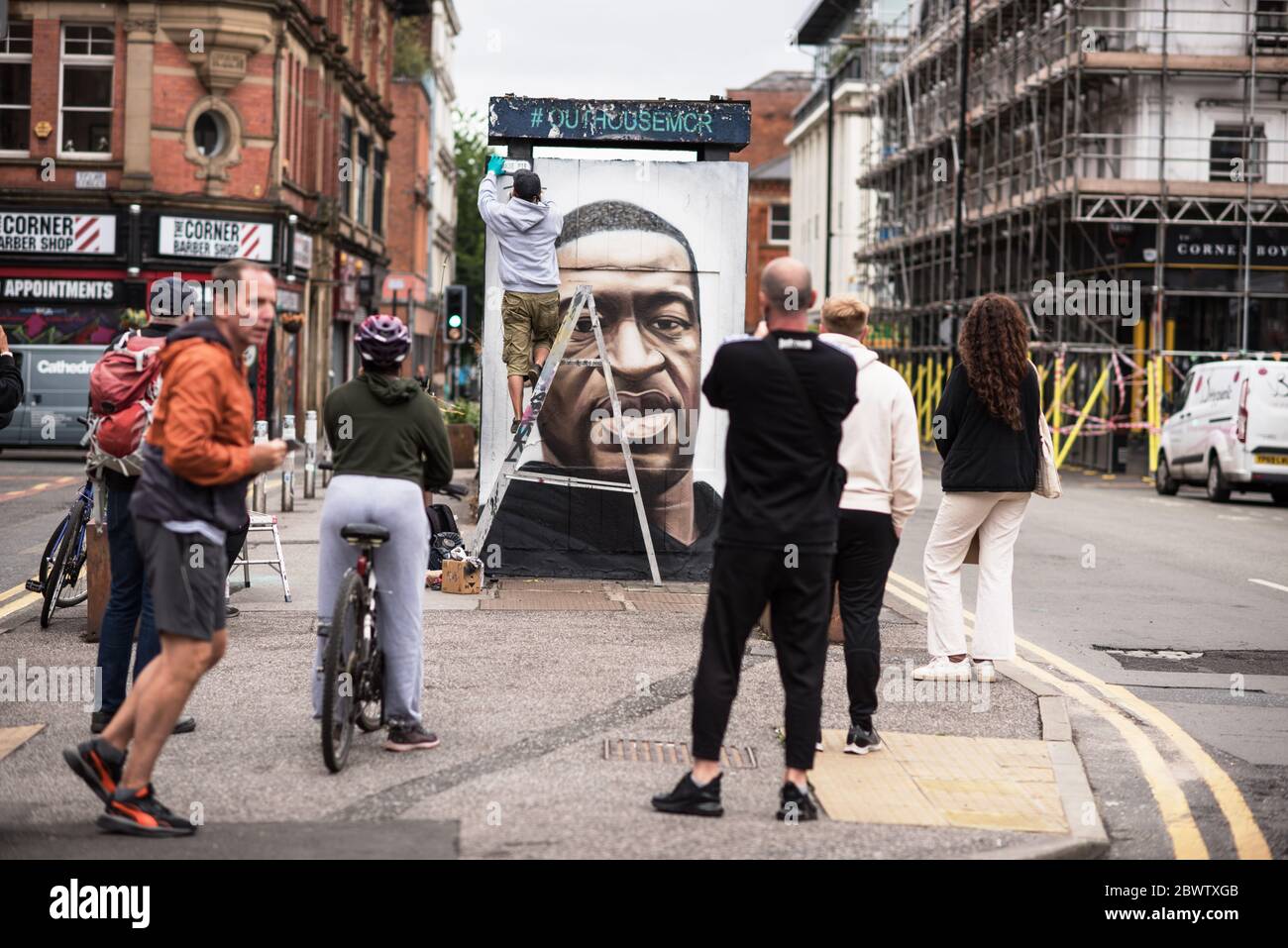 3rd June 2020. Manchester, United Kingdm. Crowds gather in Stevenson Square as French street artist AKSE p19 completes a mural of George Floyd. The mural marks the death of Floyd, a black man, after he was pinned under the knee of a white police officer in Minneapolis for almost nine minutes. Credit: Howard Harrison/Alamy Live News Stock Photo