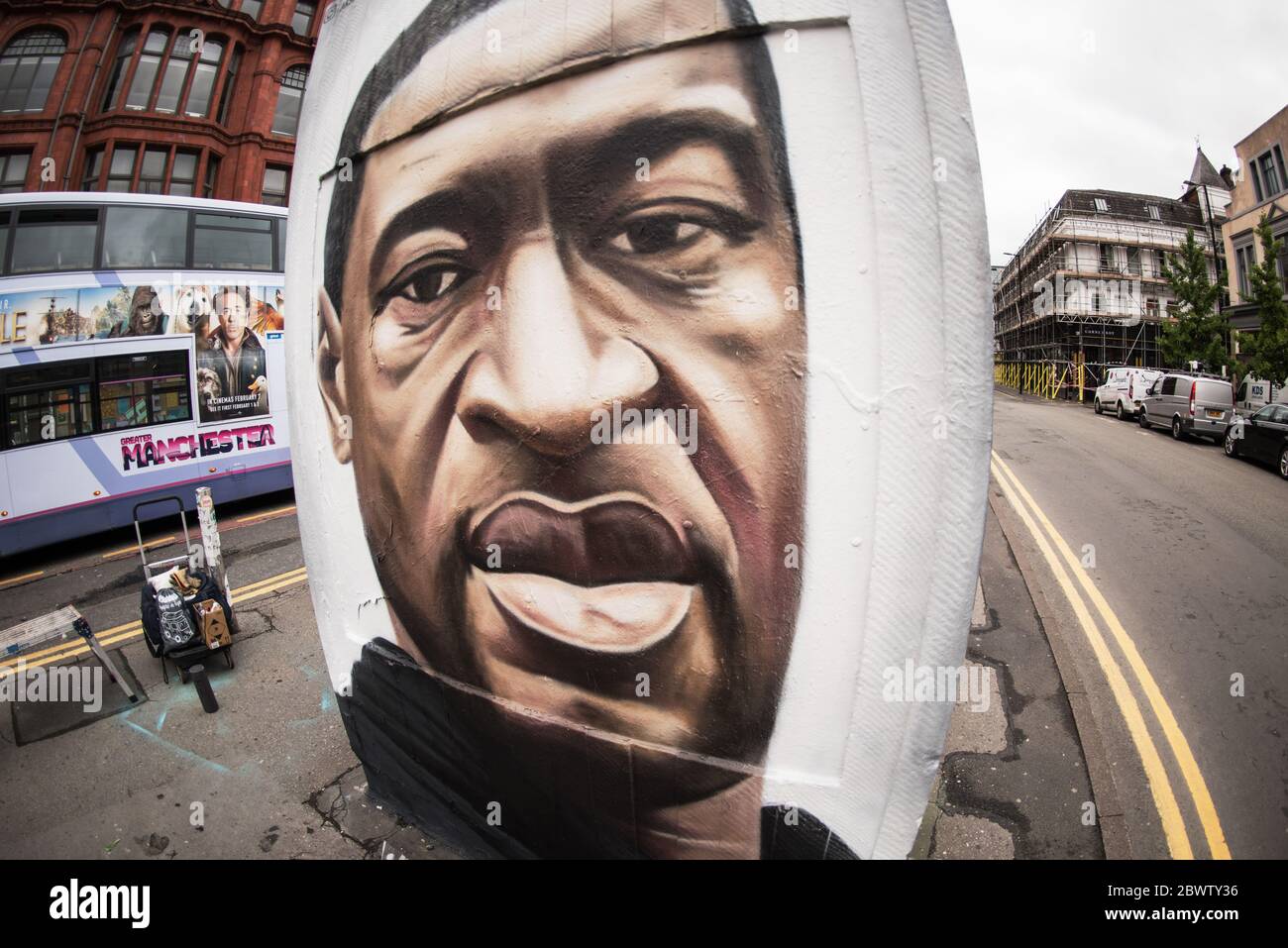 3rd June 2020. Manchester, United Kingdm. Crowds gather in Stevenson Square as French street artist AKSE p19 completes a mural of George Floyd. The mural marks the death of Floyd, a black man, after he was pinned under the knee of a white police officer in Minneapolis for almost nine minutes. Credit: Howard Harrison/Alamy Live News Stock Photo