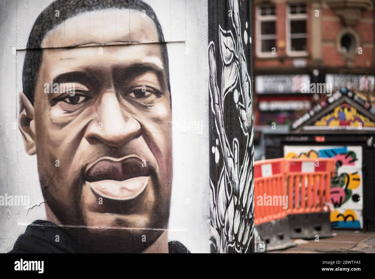 3rd June 2020. Manchester, United Kingdm. Crowds gather in Stevenson Square as French street artist AKSE p19 completes a mural of George Floyd. The mural marks the death of Floyd, a black man, after he was pinned under the knee of a white police officer in Minneapolis for almost nine minutes. Credit: Howard Harrison/Alamy Live News Stock Photo