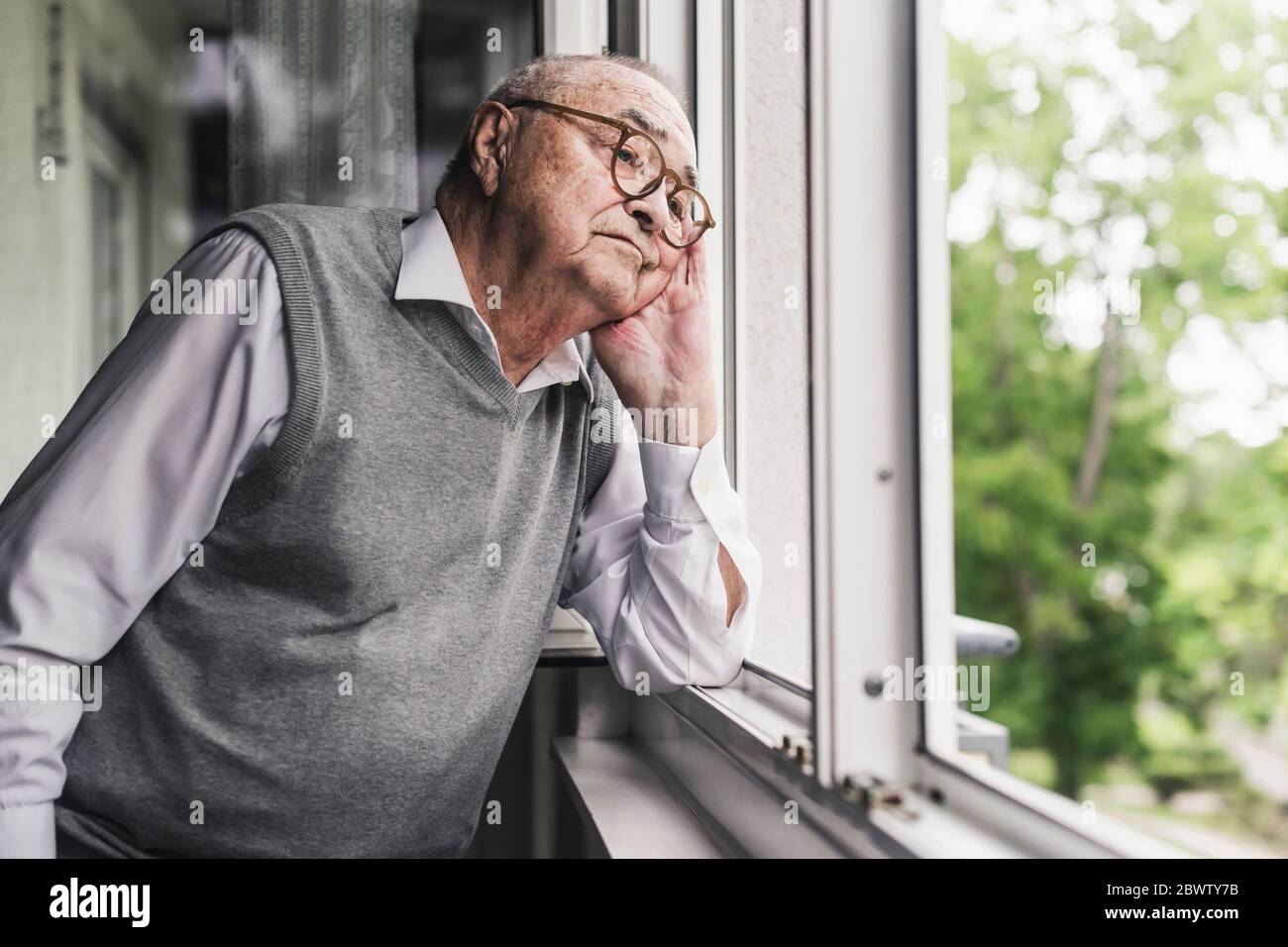 Young Man by the Window Looking Outside Stock Photo - Image of  disappointment, grief: 85427746