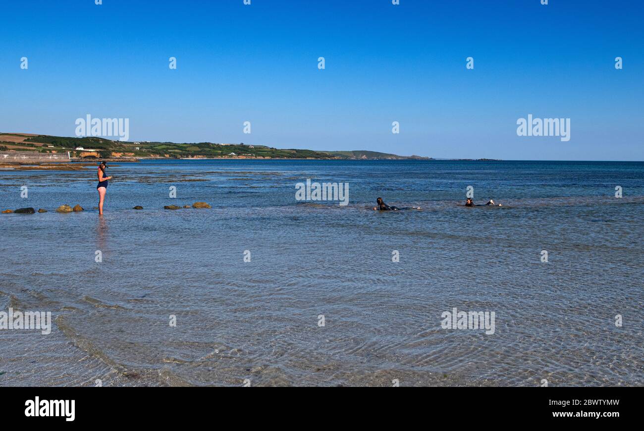 St Michael's Mount is a small tidal island with a castle and a church, in Mount's Bay, Cornwall, England, United Kingdom. social distance swimming in Stock Photo