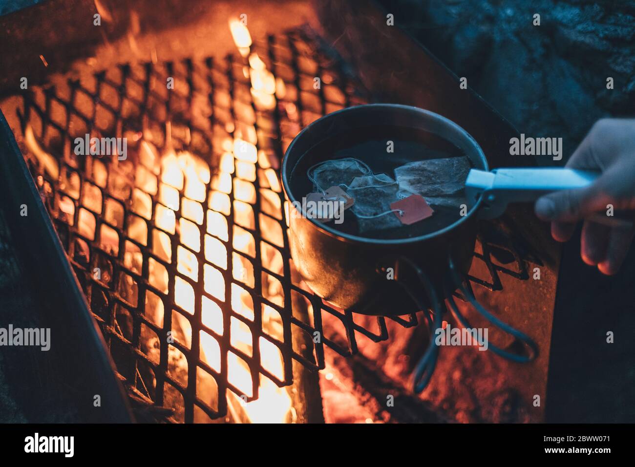Person boiling tea water in a skillet Stock Photo Alamy