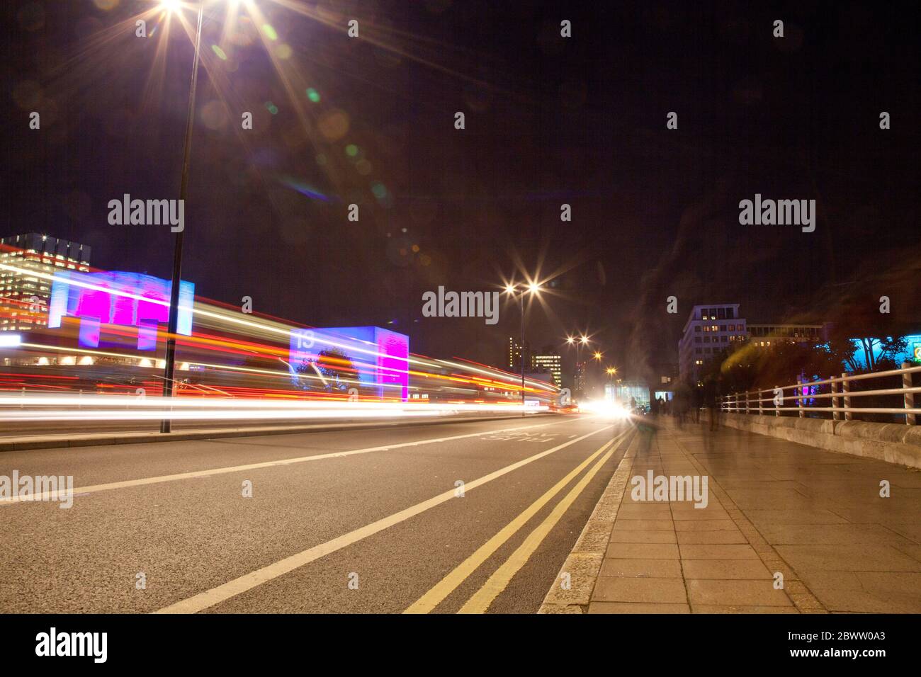 night time semi-abstract of traffic light trails on a modern concrete bridge Stock Photo