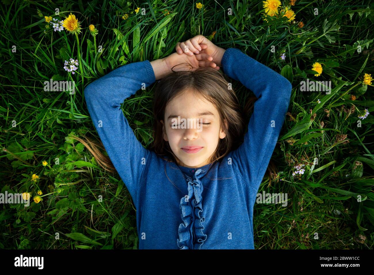 Portrait of girl with eyes closed relaxing on a meadow in spring Stock ...