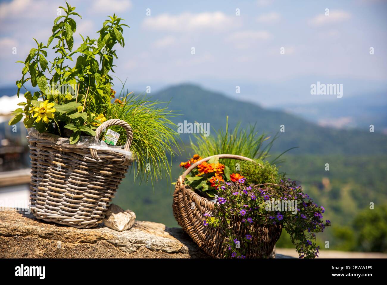 A basket with flowers at pilgrimage village of Santa Maria del Monte on Sacro Monte di Varese, UNESCO World Cultural Heritage Site, Santa Maria del Mo Stock Photo